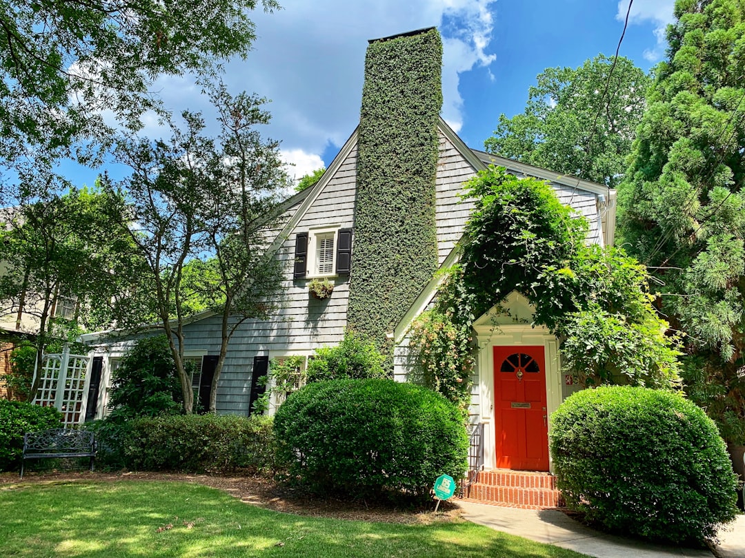 The bright, sunny exterior of a beautiful modern suburban home in Atlanta, representing the valuable asset a homeowner is trying to sell.