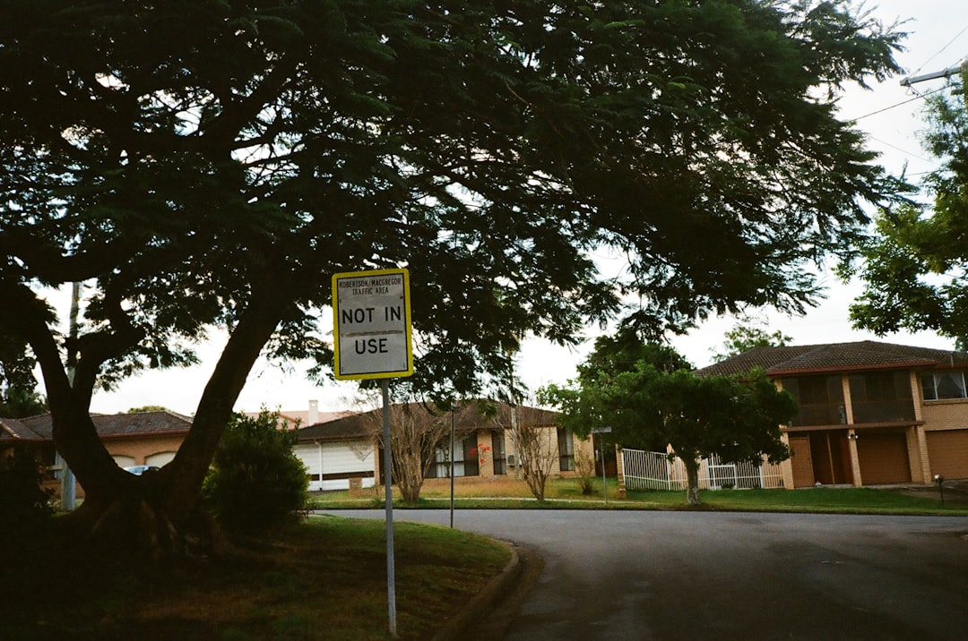 A close-up of a real estate sign with a red 'SOLD' banner across it, signifying a successful home sale and the positive outcome for the homeowner.