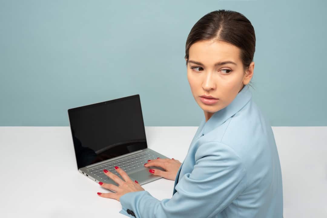 Homeowner sits at a desk looking concerned while reviewing a complex legal document, representing the stress of a real est...