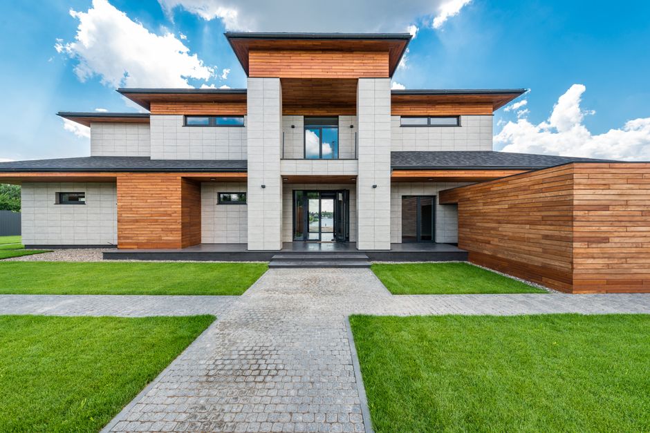 Bright, sunny photograph of a beautiful modern home in an upscale Atlanta neighborhood, representing a valuable real estat...