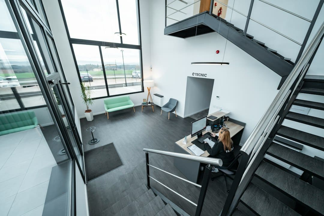 A real estate professional works efficiently on a tablet in a bright, modern office, symbolizing a tech-forward and streamlined business model.