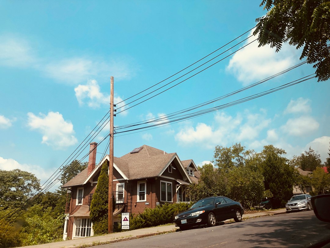 The sunny exterior of a beautiful, modern brick suburban home in Atlanta, representing a valuable real estate asset.