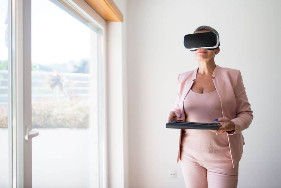 A professional Atlanta realtor presenting information on a tablet to clients in a modern living room, showcasing the tech-driven 1% commission business model.